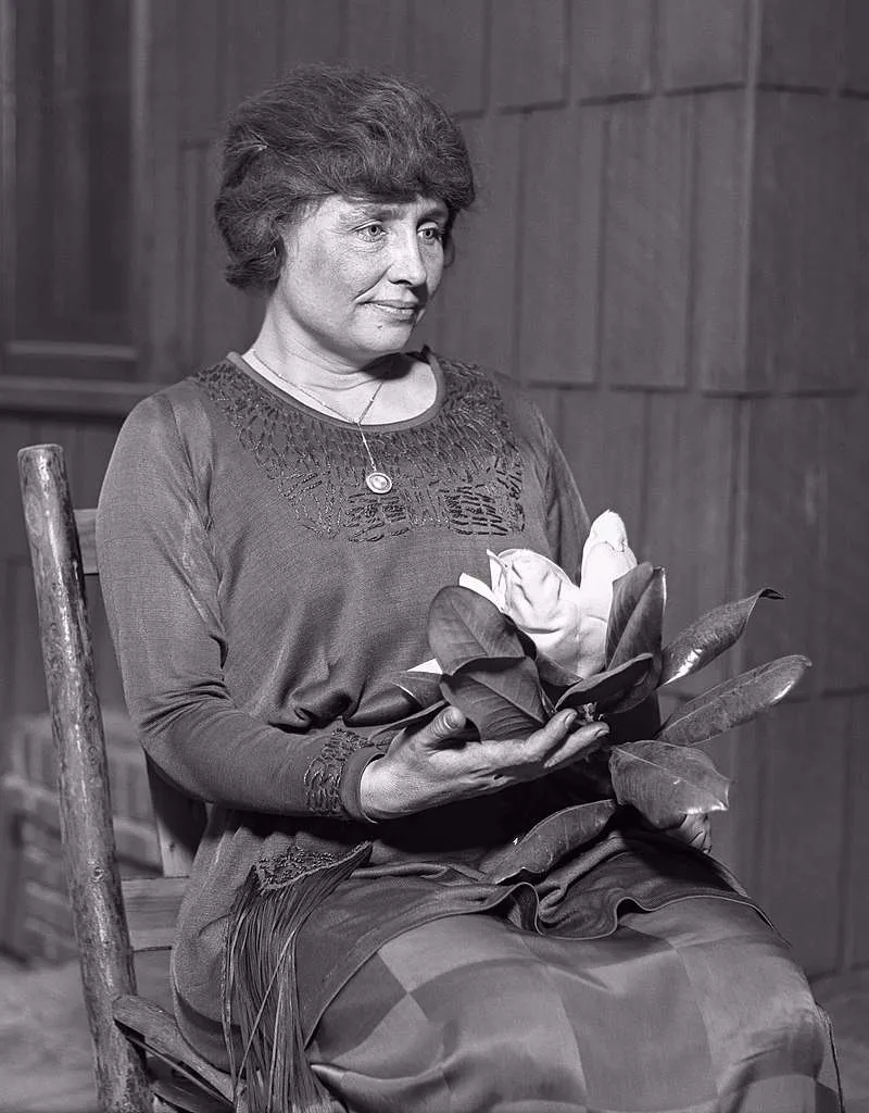 Keller holding a magnolia, c. 1920